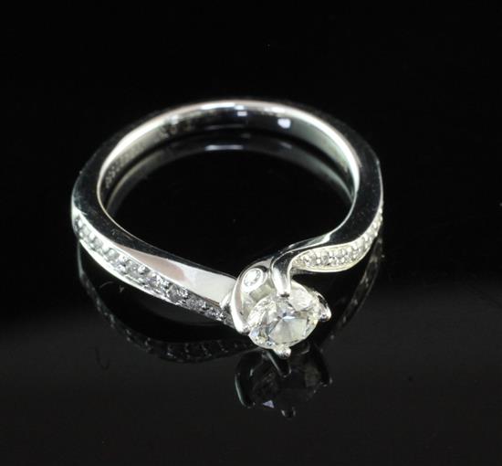 An 18ct white gold single stone diamond ring with diamond set shoulders, in Tolkowsky box, size L.